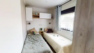 Un ou plusieurs lits dans un hébergement de l'établissement Camping Officiel Siblu Les Oyats