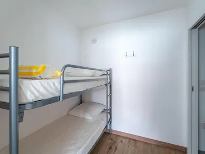 Un ou plusieurs lits dans un hébergement de l'établissement Appartement Neuf 3* à 100m de l'Océan avec Piscine pour 8 Personnes - Ménage Inclus - FR-1-50-113