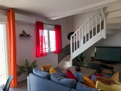 Coin salon dans l'établissement Mimizan Apt neuf 80m2 +terrasse 100m plage