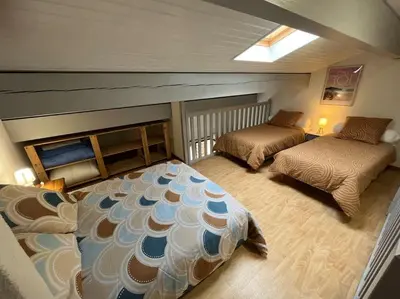Un ou plusieurs lits dans un hébergement de l'établissement Maison 400m plage